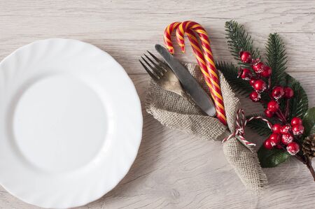 Christmas table place setting on wooden background, top view with copy space. Holidays backgroundの写真素材