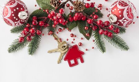 Christmas decorations: decorative house and key to the lock on white paper background, concept of finance and housing loans の写真素材