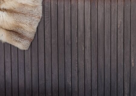 Textures red fox fur. Red fox shaggy fur texture cloth abstract, furry rusty texture plain surface on wooden background. Top view. の写真素材