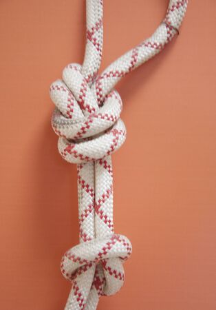 Knot on a rope for climbers. Mountaineering center. Strong knot on the climbing wall rope