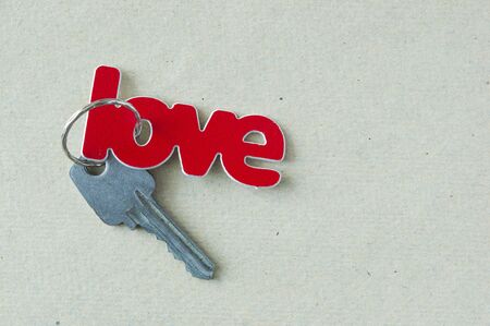 Valentine's day greeting card background with copy space. Key chain red heart shape with word love の写真素材