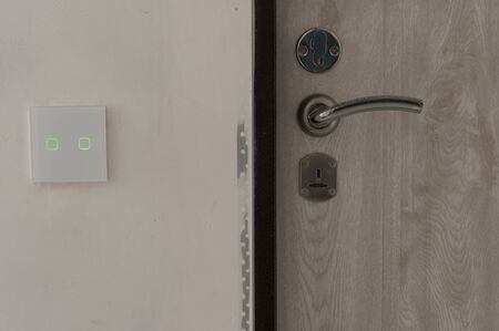 white square touch switch on white textured wall