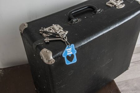 rustic leather vintage suitcases and old two keys with sign home sweet home. welcome homeの写真素材