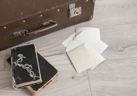 Vintage luggage with blank space of photo frame on wooden table. Journey memory concept. Top viewの写真素材