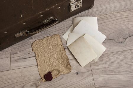 Vintage luggage with blank space of photo frame on wooden table. Journey memory concept. Top viewの写真素材