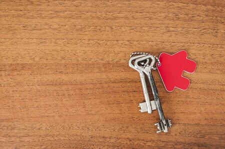 Close up of house keys on a house shaped keychainの写真素材