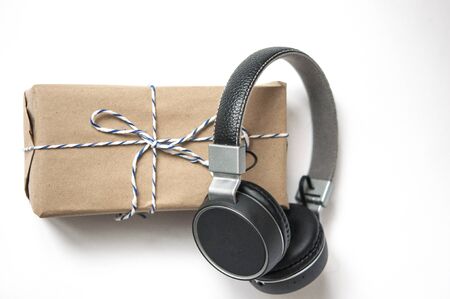 Headphones near gift box on white background. Top viewの写真素材