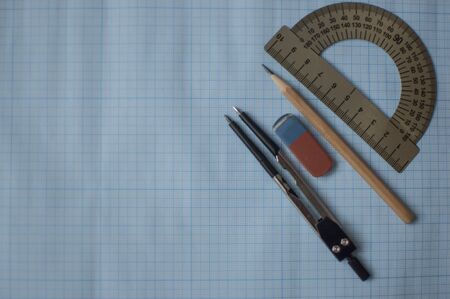 Mathematics geometry tool for student in math class with copy space for text on paper graph...