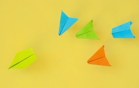 Colorful paper plane on paper background. Leadership and Business competition concepts. Copy spaceの写真素材