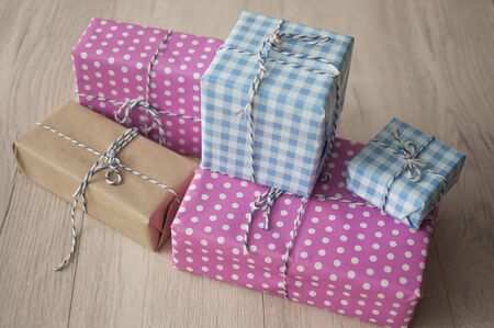 many colorful gift boxes on wooden table background