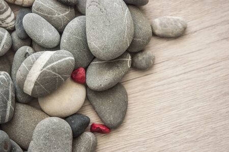 Collection of grey pebbles on white wood planks. Natural background.Top view の写真素材