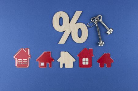 Top view. Model house with wooden sign percent. Mortgage and interest on the house. buy of property, home, real estate. affordable housing. advantageous offer from the bank. Government program.の写真素材