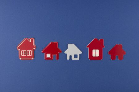 Miniature house on blue background. Top view.   Buy of property, home, real estate. affordable...