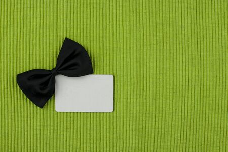 Black bow tie with blank tag for fathers day background with copy space.の写真素材