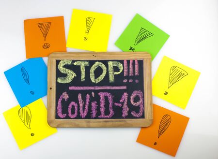 Chalk inscription stop coronavirus covid-19 on blackboard. World pandemic epidemic concept.