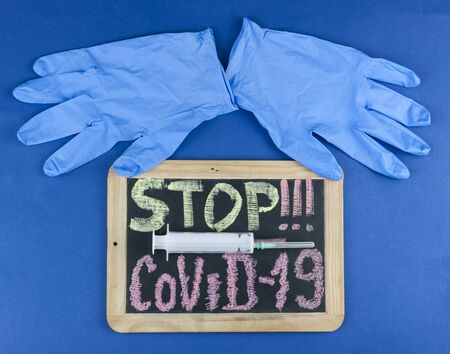 Chalk inscription stop coronavirus covid-19 on blackboard. World pandemic epidemic concept.の写真素材