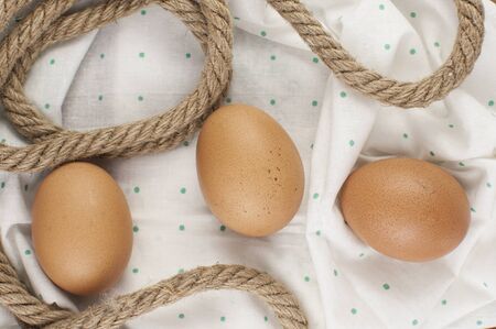 brown eggs and napkin with polka dot pattern. Happy Easter text, copy space