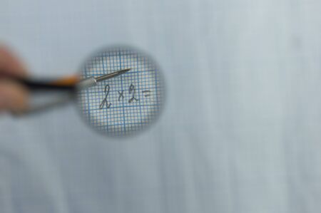 Documents, calculations and calculations by magnifying glassの写真素材