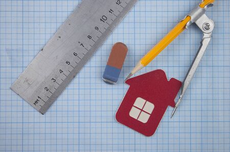 house model, ruler, drawing compass, pencils on paper graphの写真素材