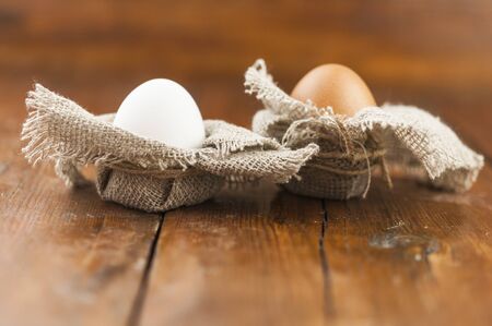 Easter in a rustic, natural style. Flat lay composition of Easter eggs on a background of burlap and...