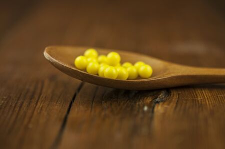 Vitamin C pills on wood spoonの写真素材