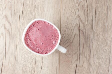 A glass of fresh cold smoothie with berriesの写真素材