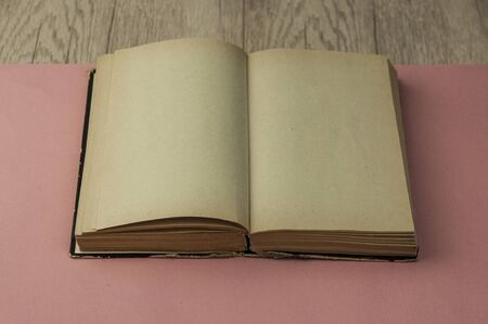 Aged blank book on wooden table, blank pages