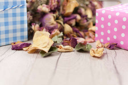 bouquet dried roses with gift box on wood background with copy spaceの写真素材