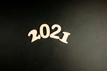 Happy New year 2021 celebration. Numeral 2021 on a dark carbon background. The inscription Postcard...