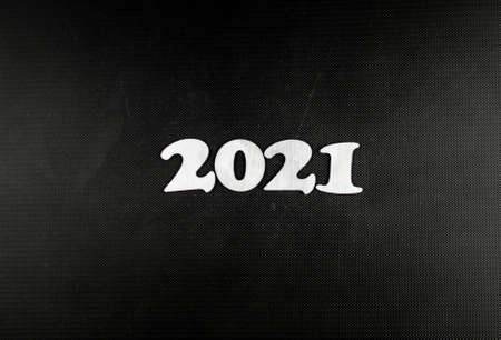 Happy New year 2021 celebration. Numeral 2021 on a dark carbon background. The inscription Postcard...