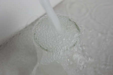 pouring water into a glass