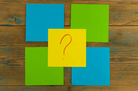 questions, decision making or uncertainty concept - a pile of colorful sticky notes with question...