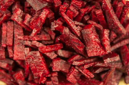 beet red raw cut into strips on a cutting board