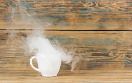 hot coffee and smoke on wooden dark backgroundの写真素材