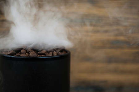 macro coffee beans in aroma smokeの写真素材