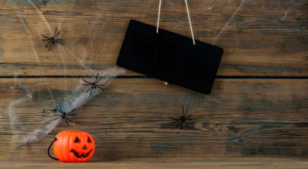 white spider web and pumpkin. wood background. Copy space. Halloween cardの写真素材