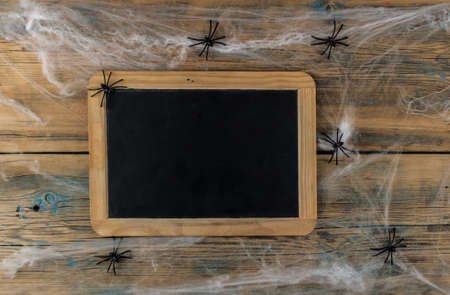 cobweb or spider web with blank chalkboard on wooden texture background wallの写真素材