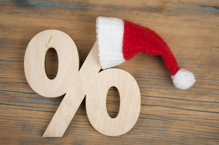 Symbol of percent and a christmas hat