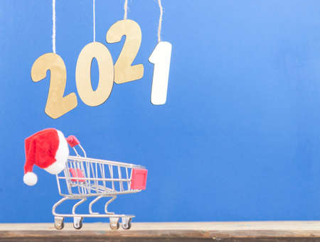 Flying in the form of New Year's numbers 2021 on a blue background. Happy New Year 2021 and Merry...