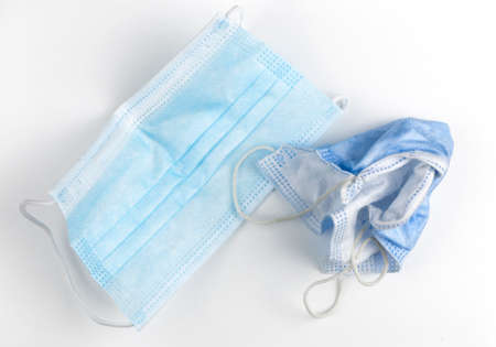 Used blue face mask on white background