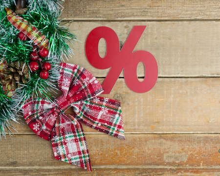 red sign percentage with Christmas wreath on a old barn plank background, top view. Christmas big sale.の写真素材