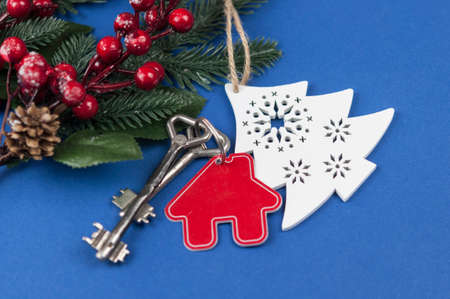 Beautiful Christmas background: decorative house and key to the lock. Concept of finance and housing...