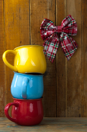 Vintage tone colorful coffee cups with copy space on wood board, stack coffee cupの写真素材