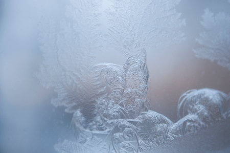 Photographing macro ice on the glass in winter. Beautiful festive frosty pattern with white...