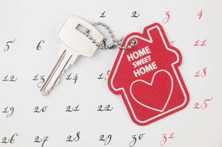 A house key on a calendar backgroundの写真素材