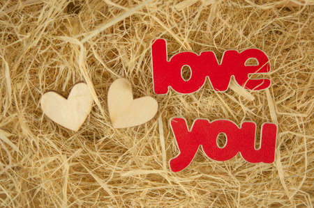Dry yellow straw grass background texture after havest with two hearts. Top view, copy space.の写真素材