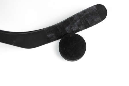 A fragment of a hockey stick and puck on a white backgroundの写真素材