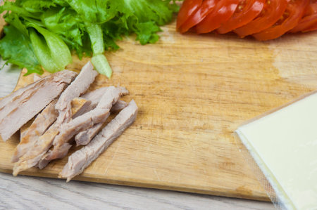 Sandwich with ham, cheese, tomatoes, lettuce, and toasted bread. Above view on white background.の写真素材