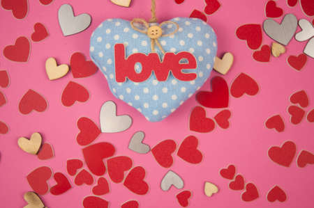 Word Love you and red hearts on pink background. Birthday or Valentines day greeting cardの写真素材