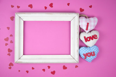 Valentine's Day composition. Photo frame and hearts on pastel pink background. Wedding. Birthday. Happy woman's day. Mothers Day. Flat lay, top view, copy spaceの写真素材